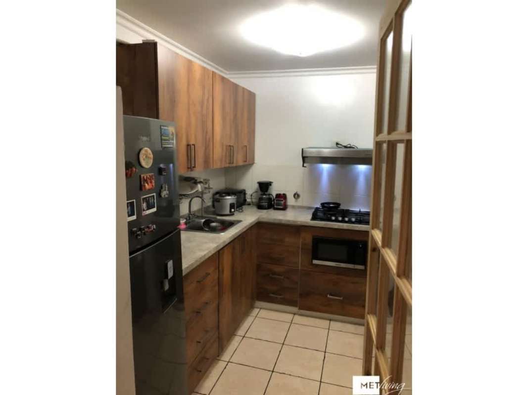 Functional kitchen with wood cabinetry and granite-style counters PH Altos de la Colina Panama City