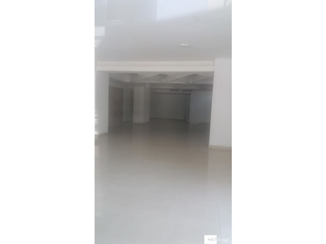 Exterior view of commercial storefront with large glass doors and covered walkway at PH Plaza Brasil Via Brasil Panama City