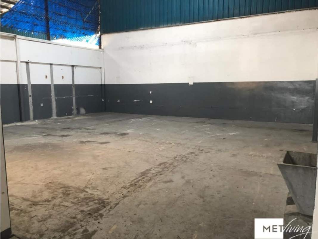 Industrial warehouse corridor with blue metal doors Parque Lefevre Panama