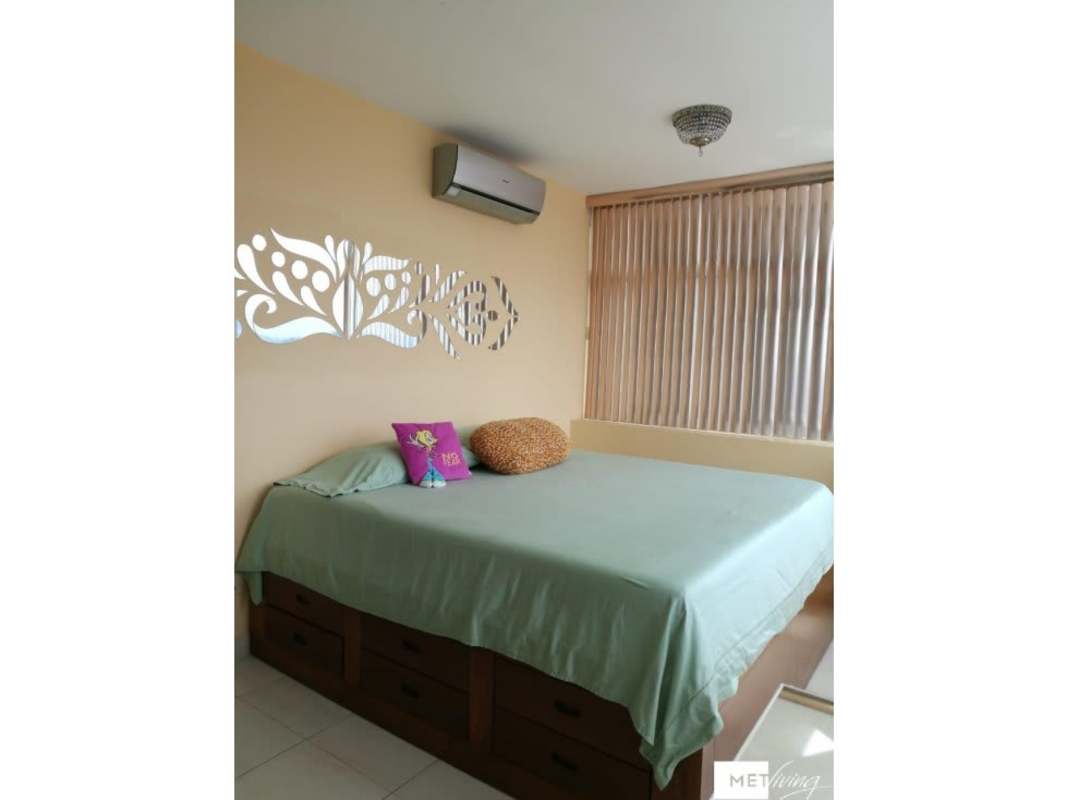 Modern kitchen with granite countertops, white cabinetry, gas stove and stainless steel appliances in Edison Park Panama apartment