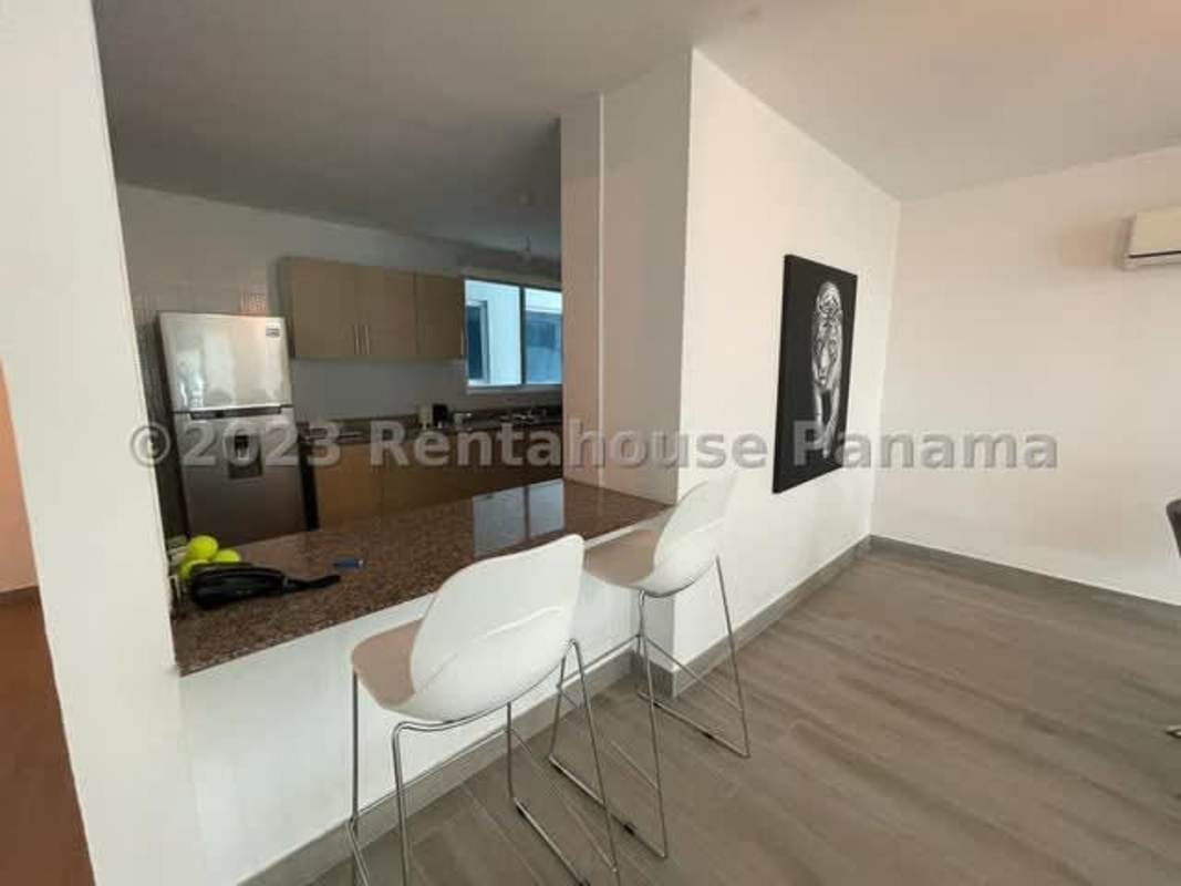 Contemporary open kitchen with breakfast bar stainless appliances and dining area in PH Blue Park Panama