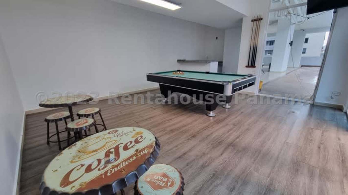 Indoor game room with pool table and seating PH Blue Park Bella Vista