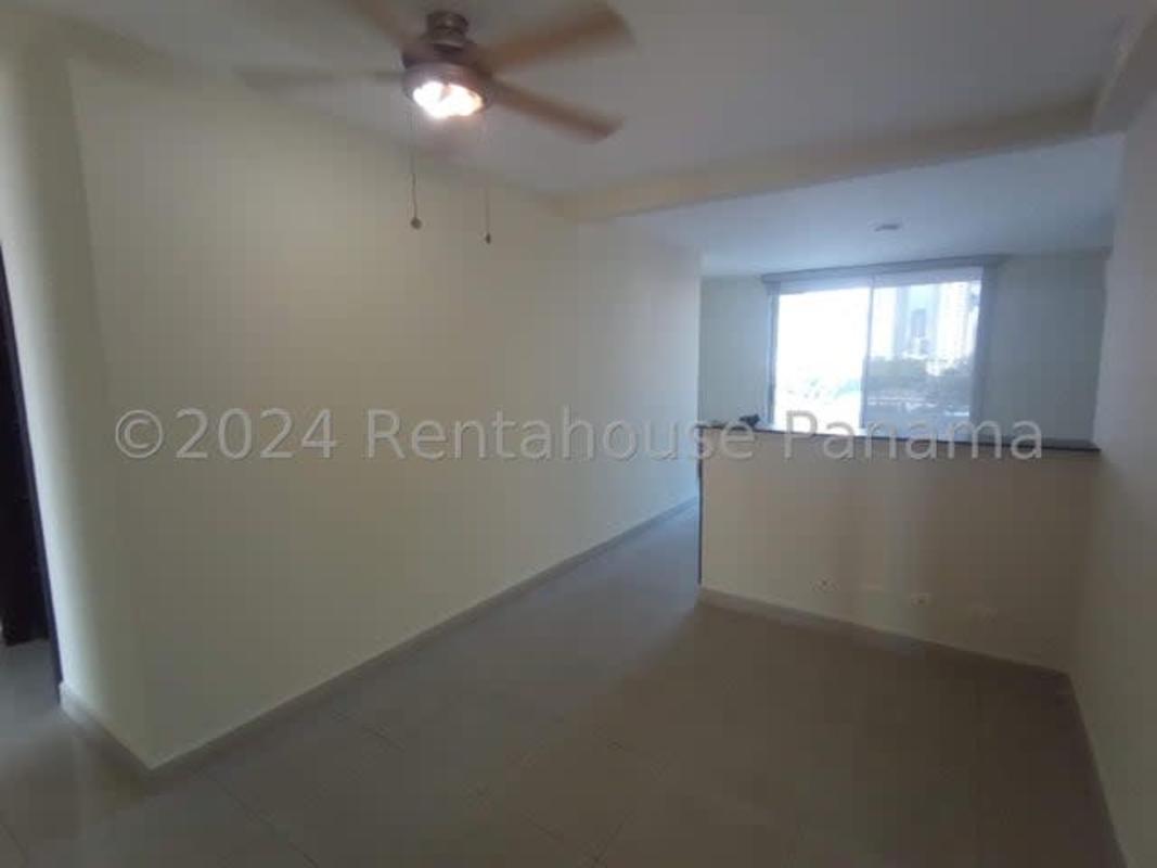 Large living room in apartment with floor-to-ceiling windows and skyline view at PH San Francisco Sky Tower Panama