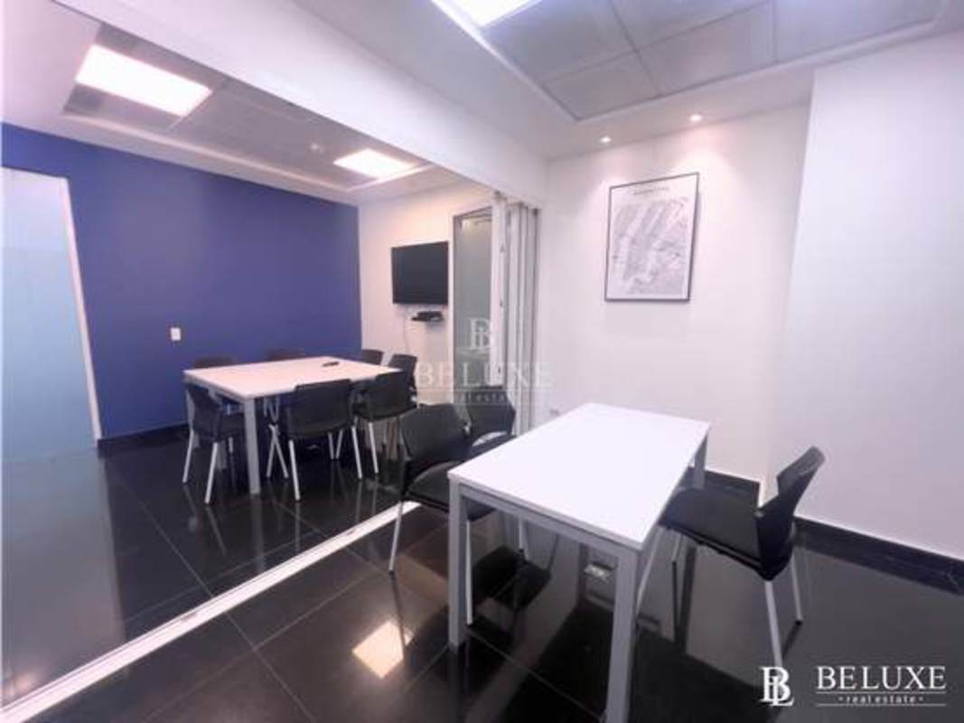 Office kitchenette with granite counters and lounge area in Torre Banesco corporate office