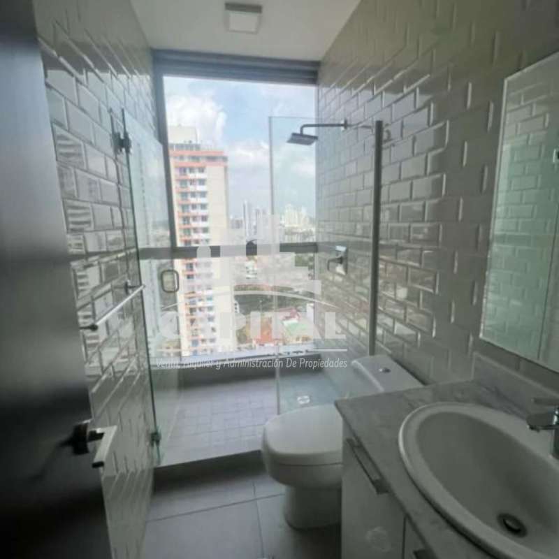 Bright master bedroom with large window and city skyline view in PH Titanium Panama