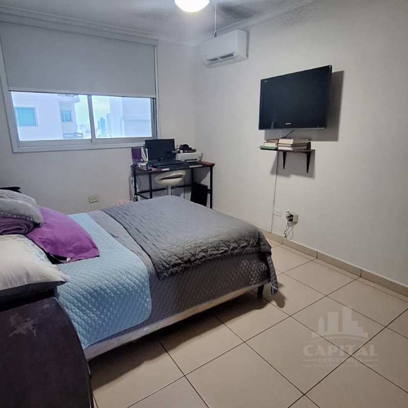 Modern dining area with stone accents and view into kitchen in PH Constellation Tower Panama