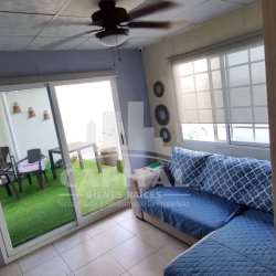 Bright bedroom with ceiling fan, window, and tile floors in Villas de Montelimar Panama