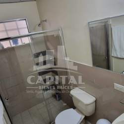 Bathroom with glass shower enclosure sink mirror in Villas de Montelimar Panama