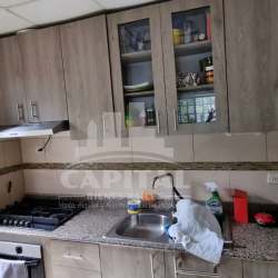 Covered patio area with artificial grass, ceiling fans and TV Villas de Montelimar Panama