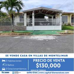 Exterior of single-family house with porch, driveway and palm tree in Villas de Montelimar Panama