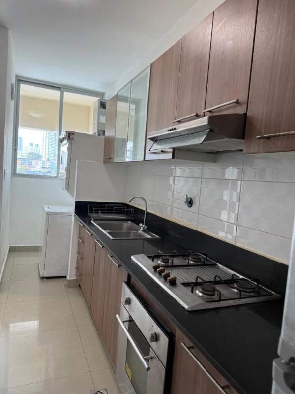 Galley kitchen with cabinets, stove, oven, double sink, large window city view San Francisco Bay Panama