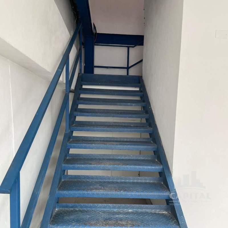 Blue metal staircase inside warehouse leading to mezzanine office Tocumen Panama