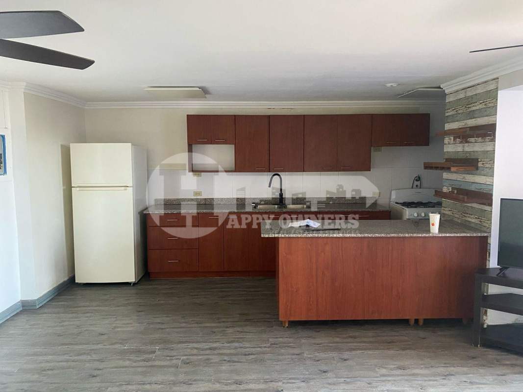 Open kitchen with granite countertop, wood cabinets in PH Lomas Carrasquilla near Parque Omar Panama