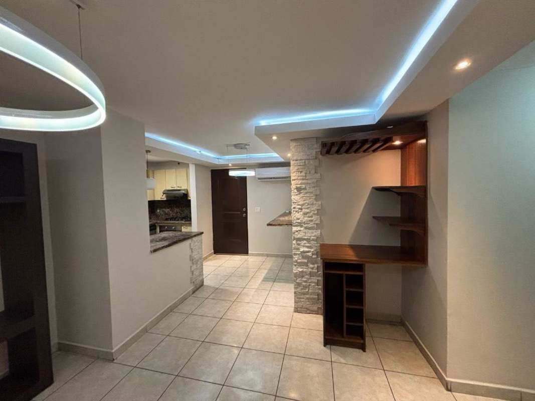 Open-plan dining with stone columns, LED lights and wooden bar in PH Sunshine Carrasquilla San Francisco Panama