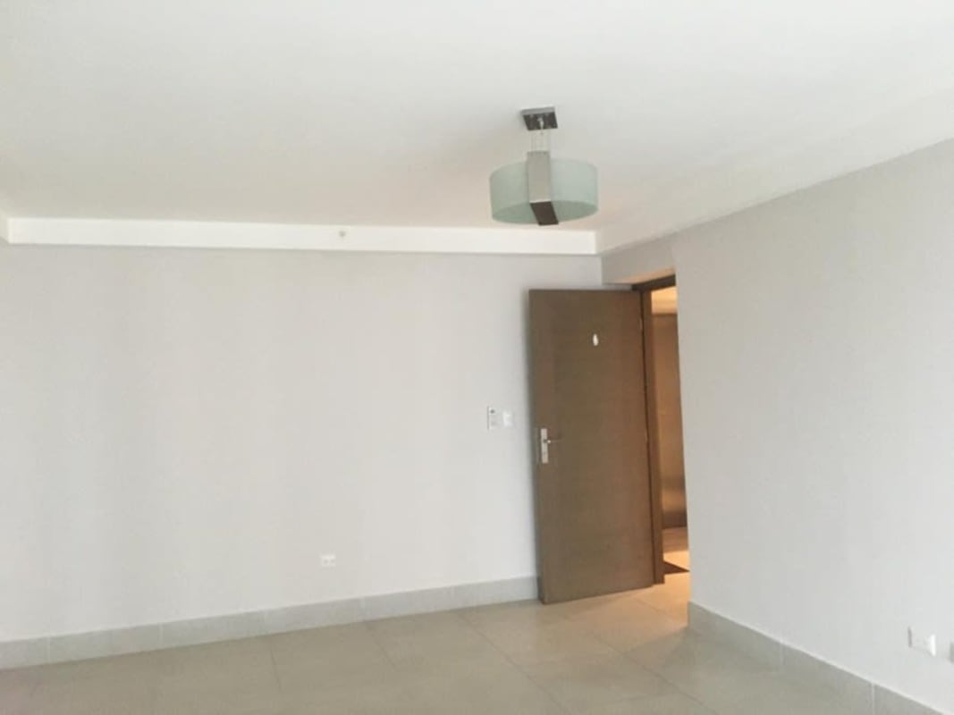 Covered terrace with infinity pool, glass railing and skyline views in Obarrio Panama City