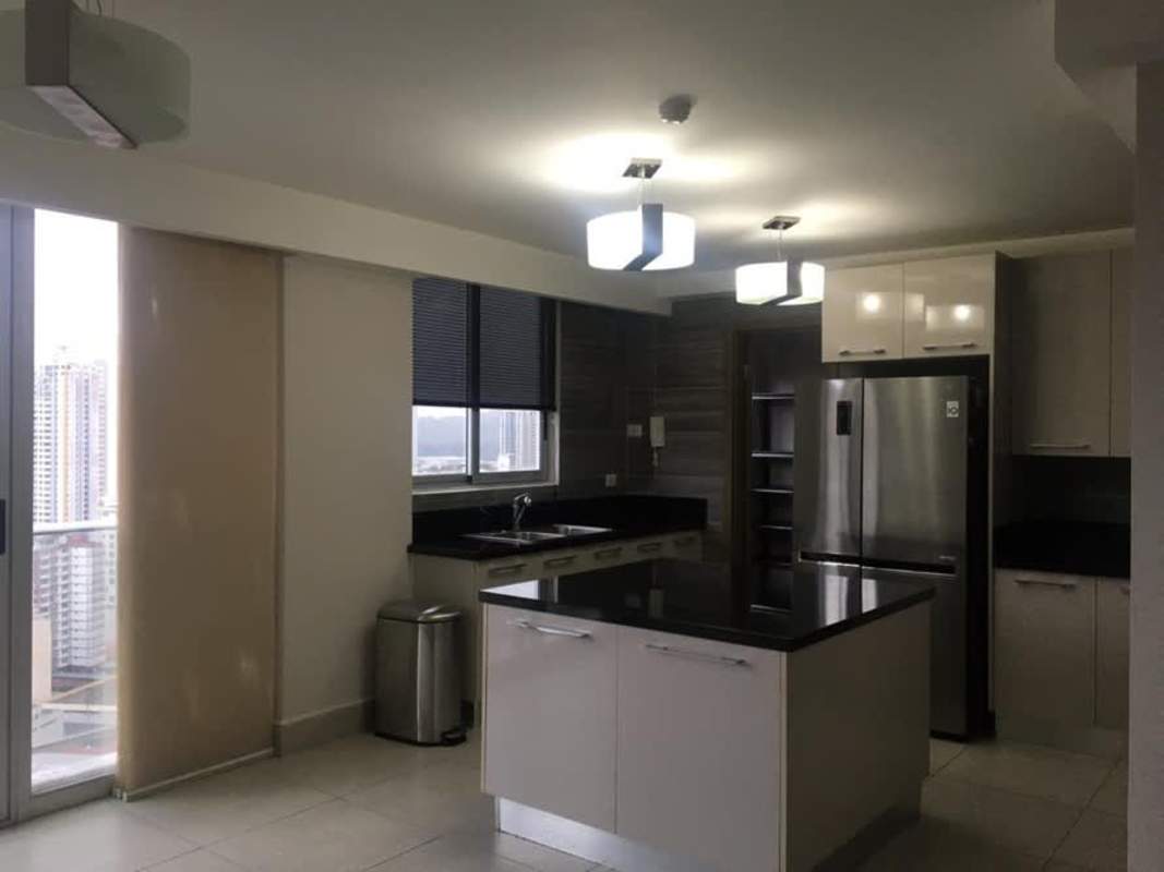 Kitchen with granite countertops, island, stainless appliances and city view at Park City Tower Panama