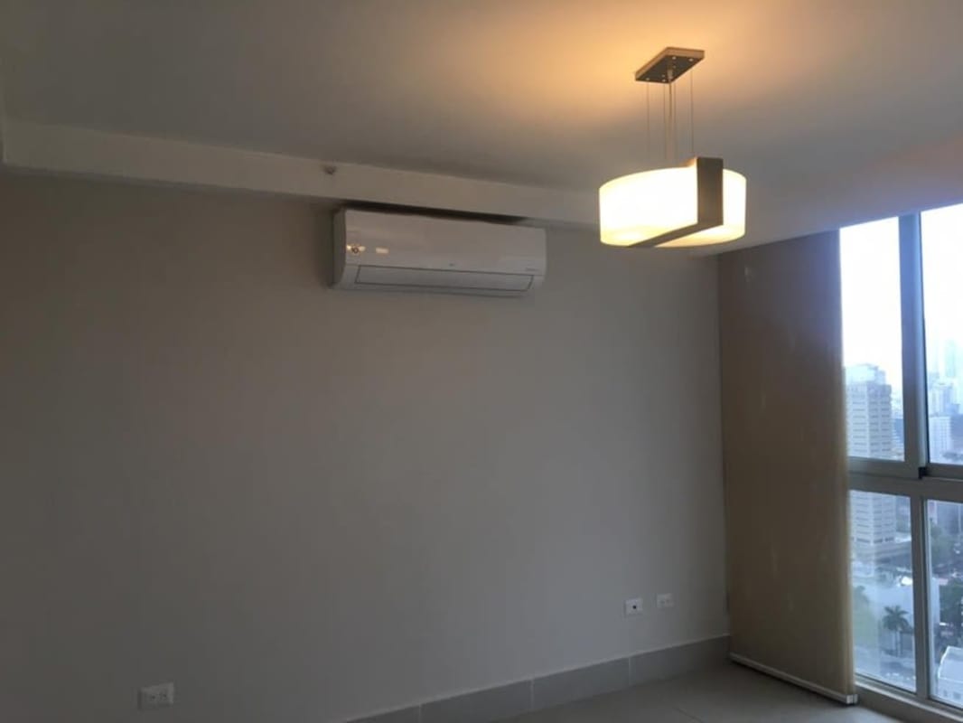 Bright minimalist living space with modern lighting and city views in Obarrio Panama City