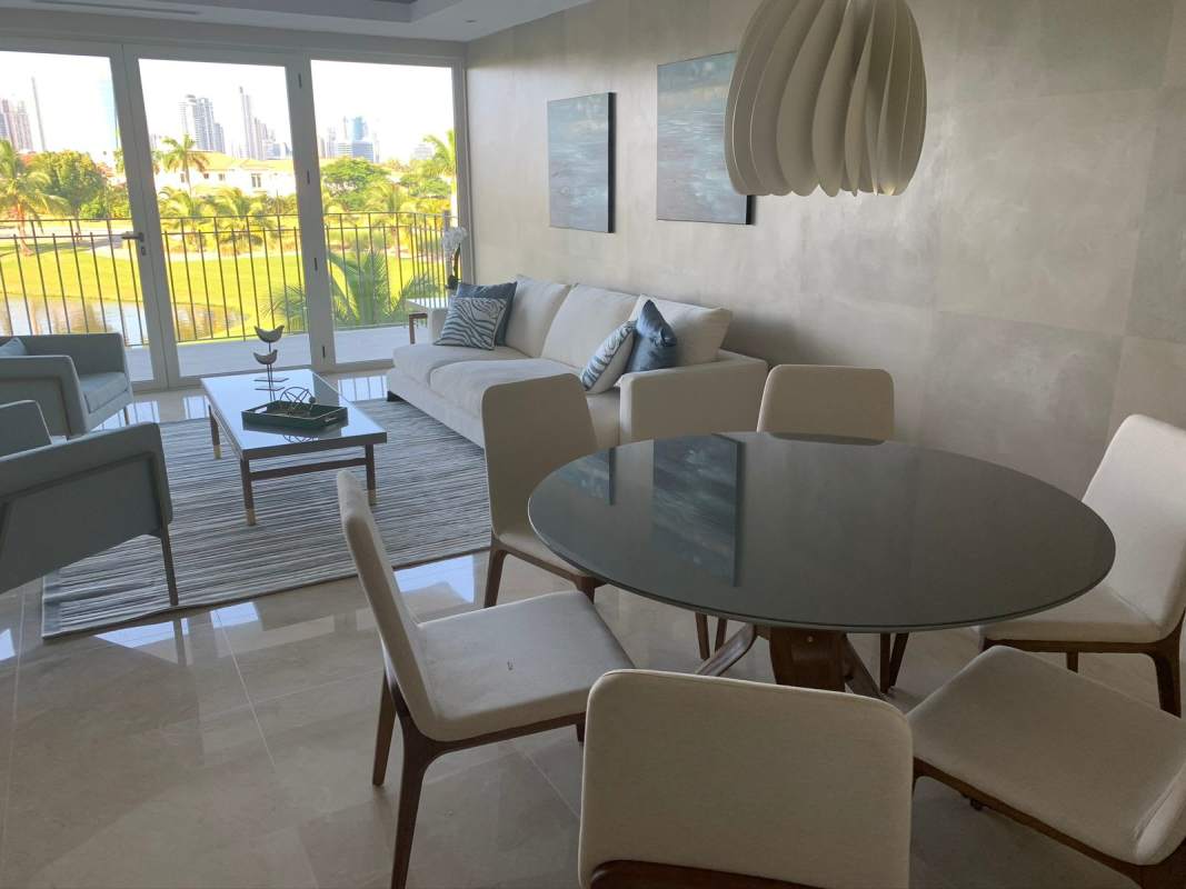 Modern living room with large windows, skyline, golf views in PH Ocean House Santa Maria Panama