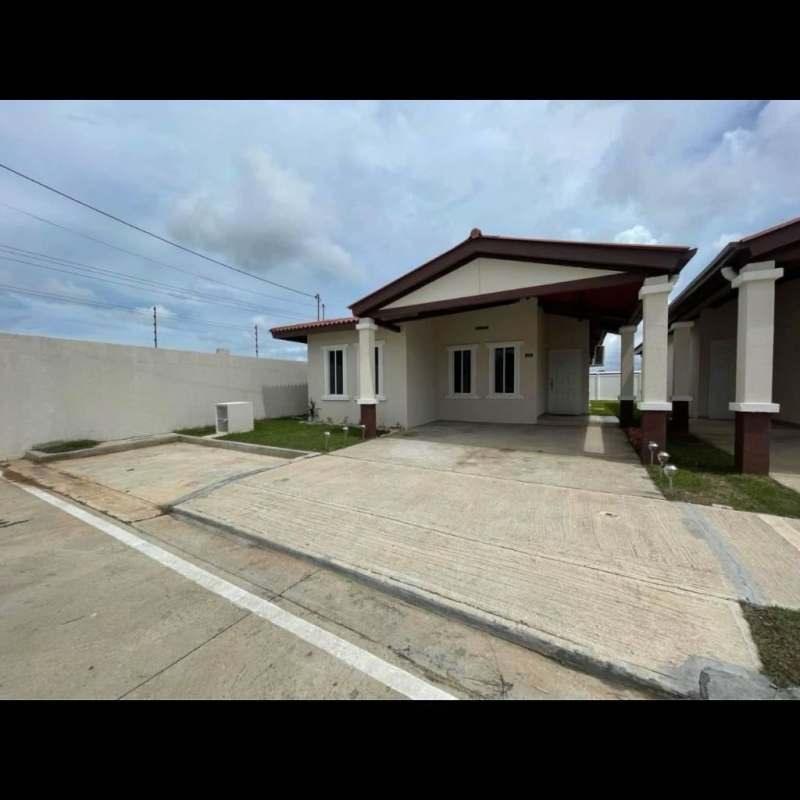 Side yard and backyard with lawn and exterior of house in Pacora Panama