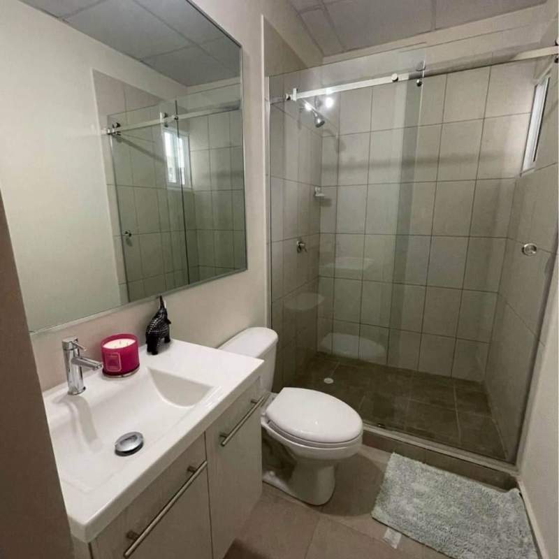 Bathroom with glass shower door, vanity and toilet in Pacora Panama