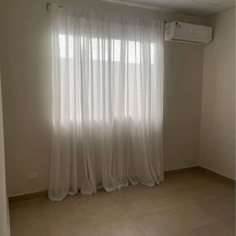 Bedroom with AC unit, window, neutral decor in rental house Pacora Panama