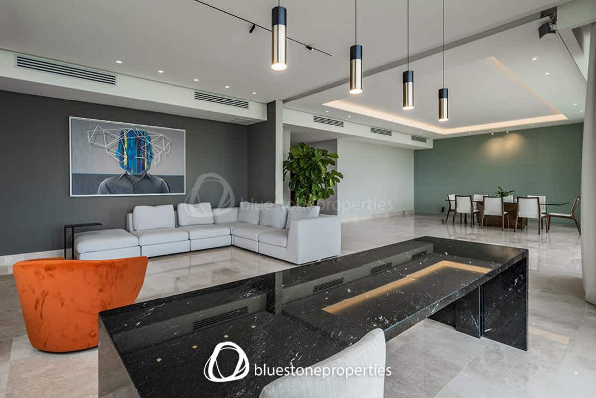 Spacious remodeled kitchen with island, white cabinetry and stainless appliances in Santa Maria Panama apartment