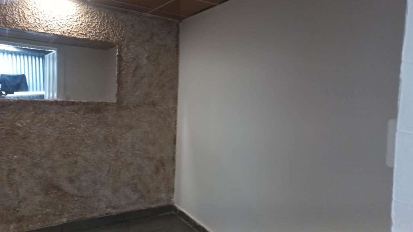 Unfinished room with textured wall and interior window Pedregal rental apartment