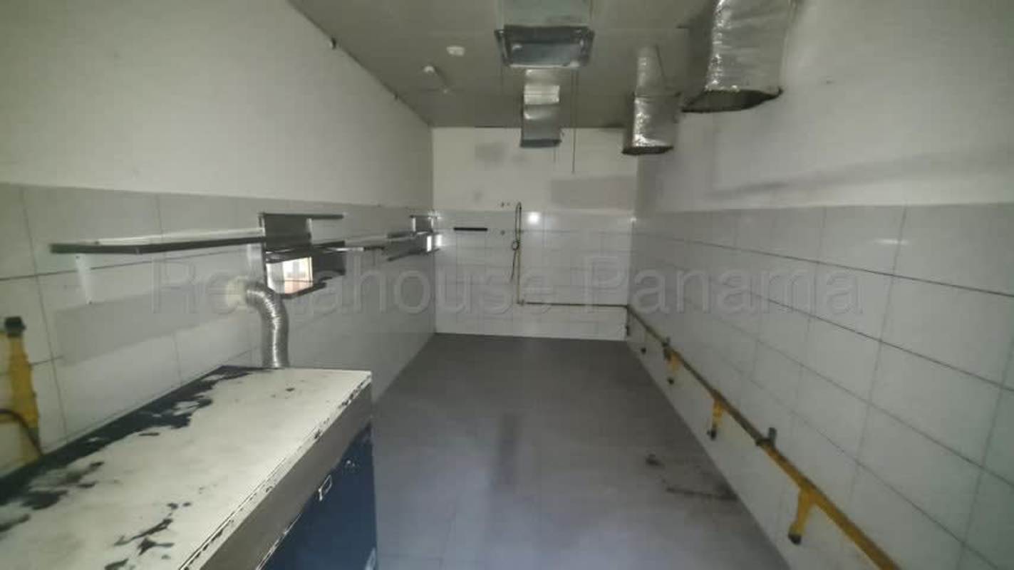 Modern loft area with wood floors and teal accent suitable for business in Panama