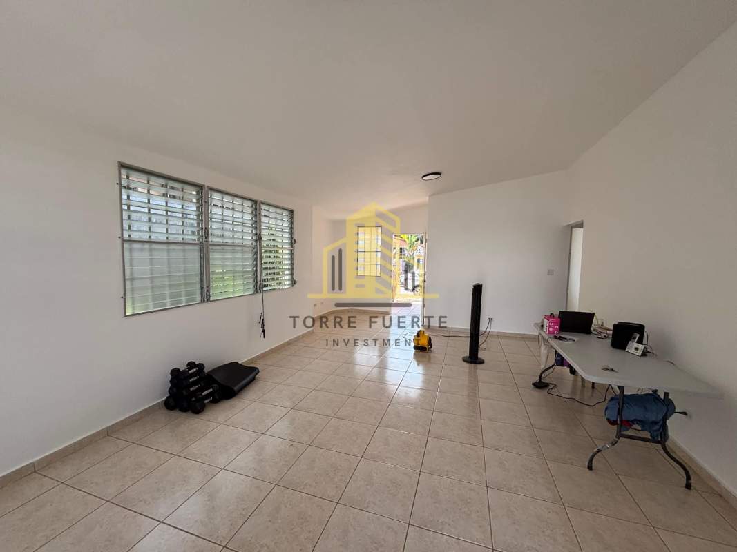 Large tiled living room with windows and natural light in Brisas del Golf Panama