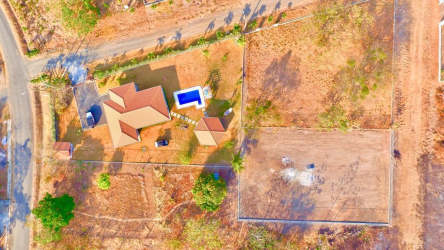 Aerial shot of fenced property with adjacent homes and dry tropical landscape in Bejuco Panama