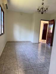 Living room with ceramic tiles, natural light, traditional ceiling light in Villa Laura David Panama