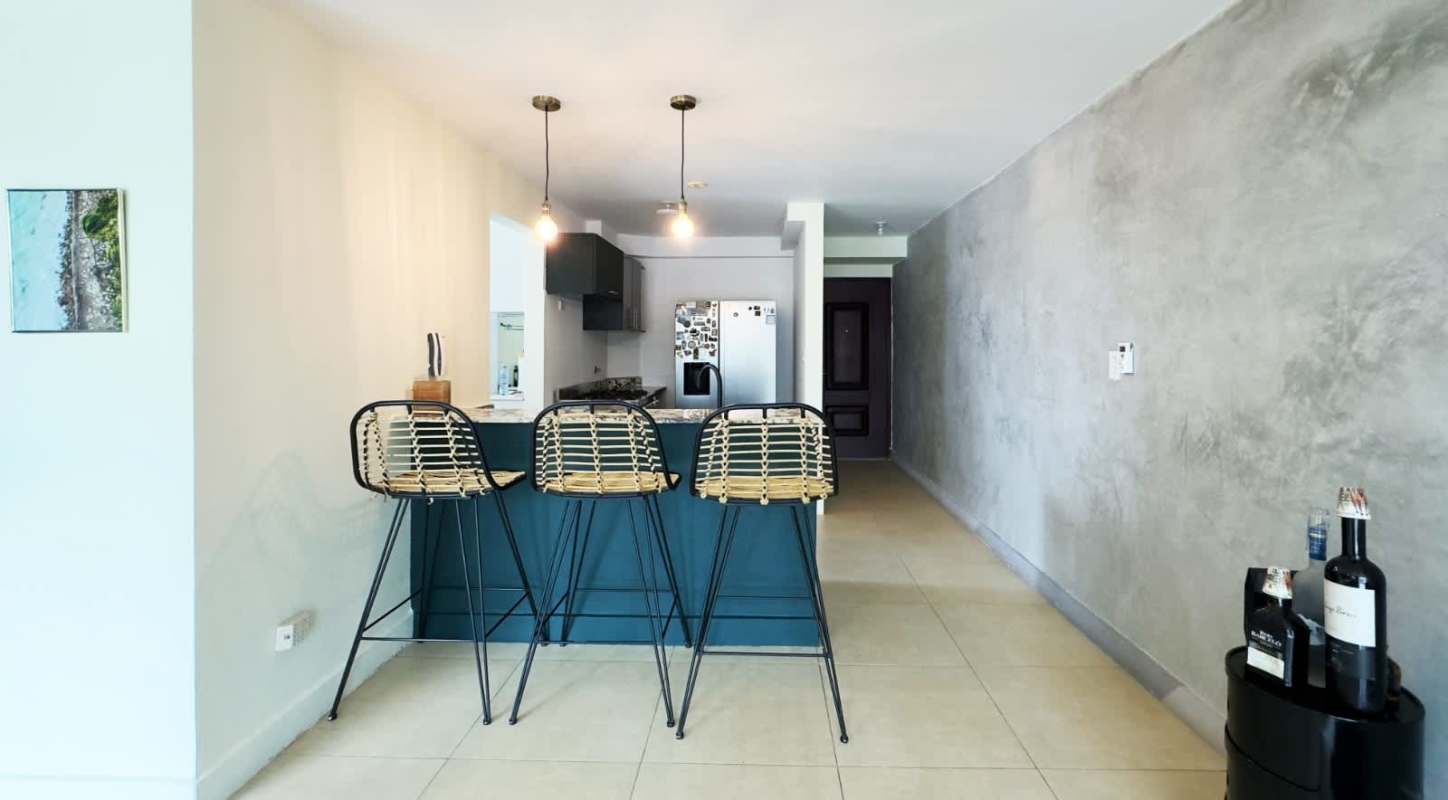 Open modern kitchen with bar seating and appliances in PH Villa Cáceres Betania Panama
