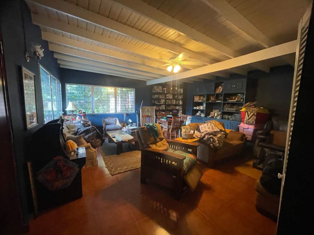 Spacious rustic kitchen with island, wooden beams, stainless appliances at Panama City estate