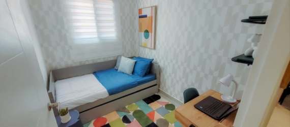 Compact bedroom with desk, window blind, geometric decor in PH Valle del Río Puerto Caimito