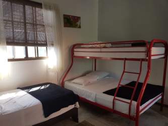 Modern bathroom with double sink vanity and large mirror in Coronado Panama beach house