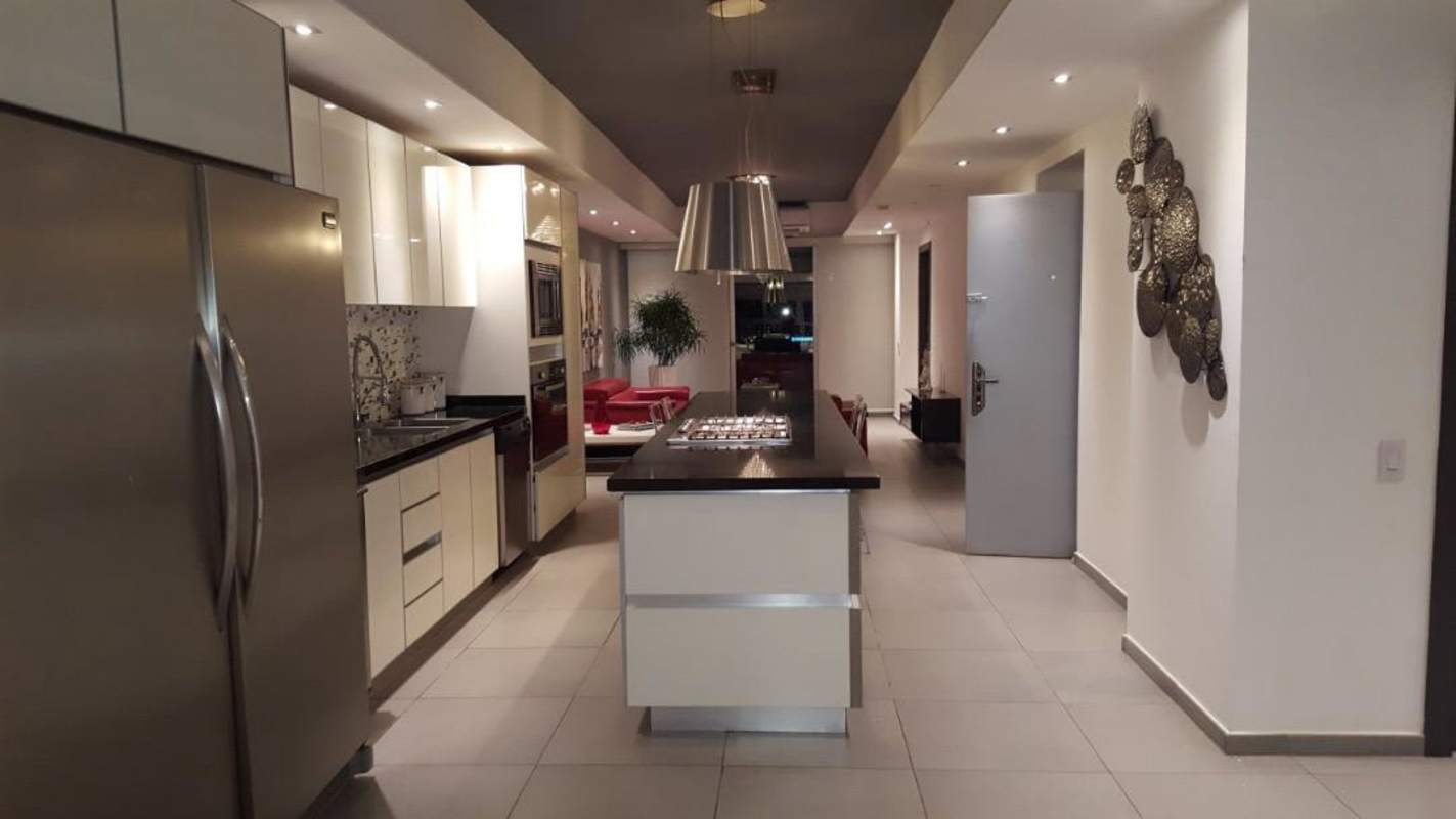 Spacious open-plan kitchen stainless appliances granite island in Yacht Club Tower Panama