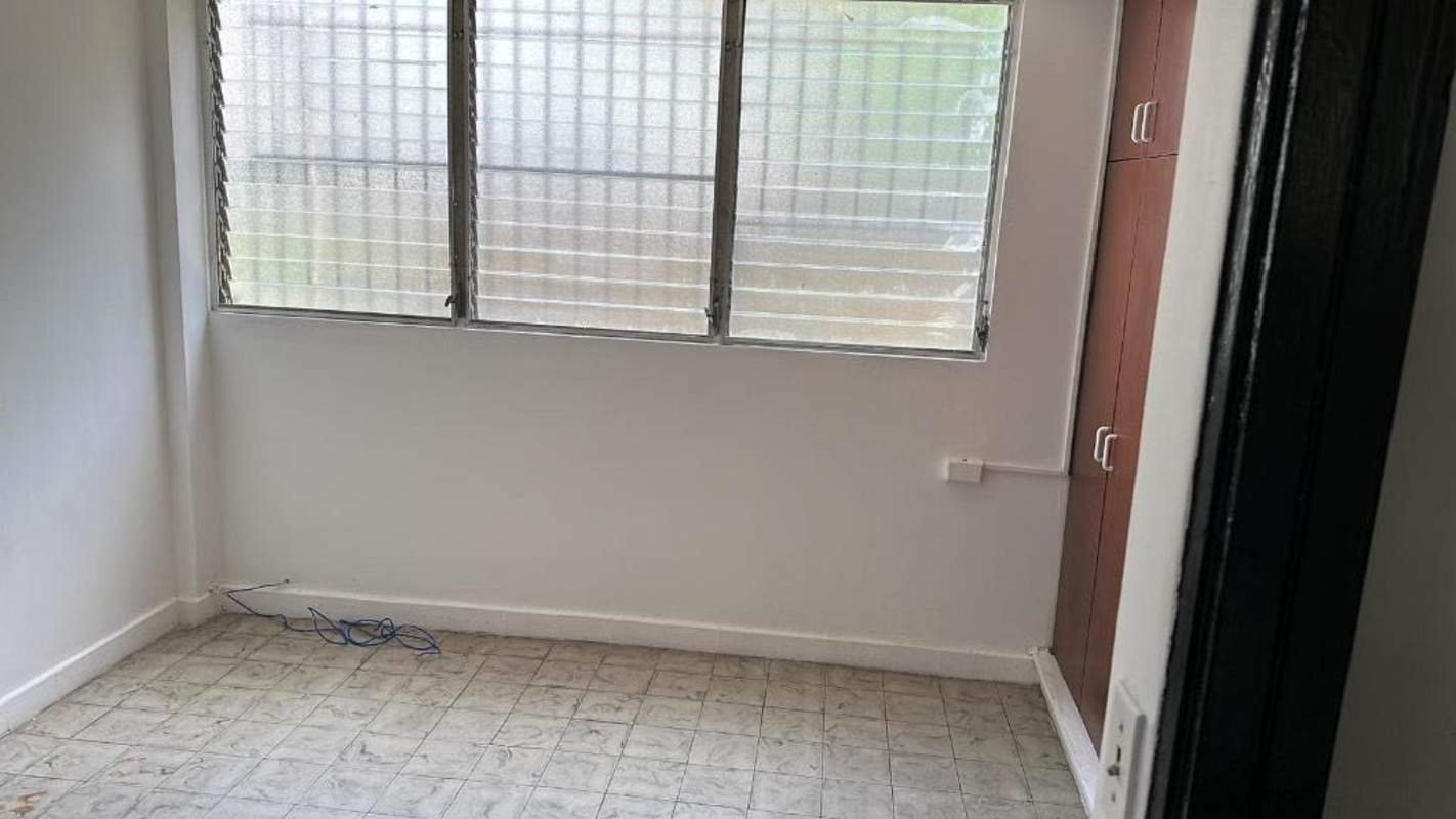 Living room with large sliding doors opening to balcony in PH Via Argentina Panama City