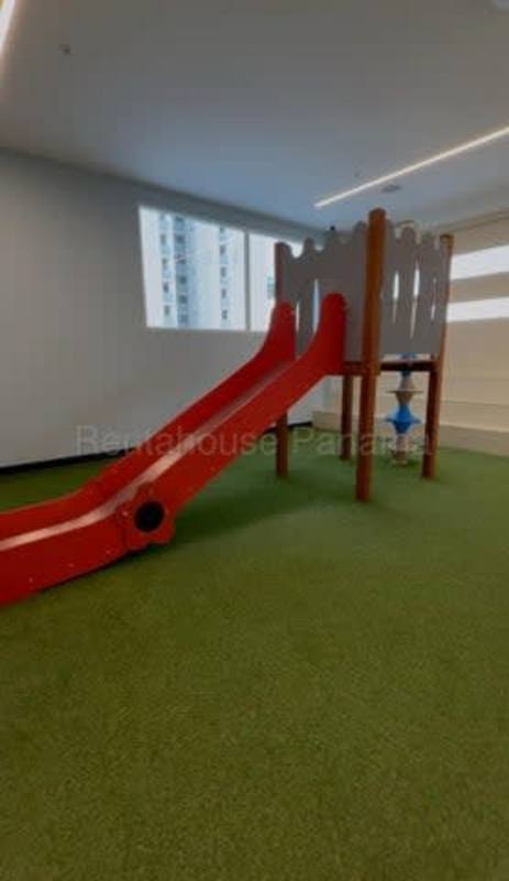 Indoor kids play area with slide and flooring in rental condo Panama