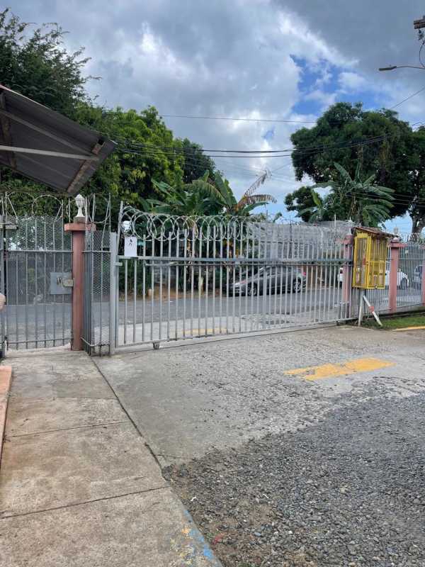 Small bathroom with shower, wall sink, window and shelving in Rio Abajo Panama apartment