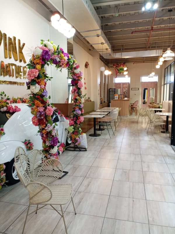 Floral archway inside modern cafe space with decorative decor in Casco Viejo Panama