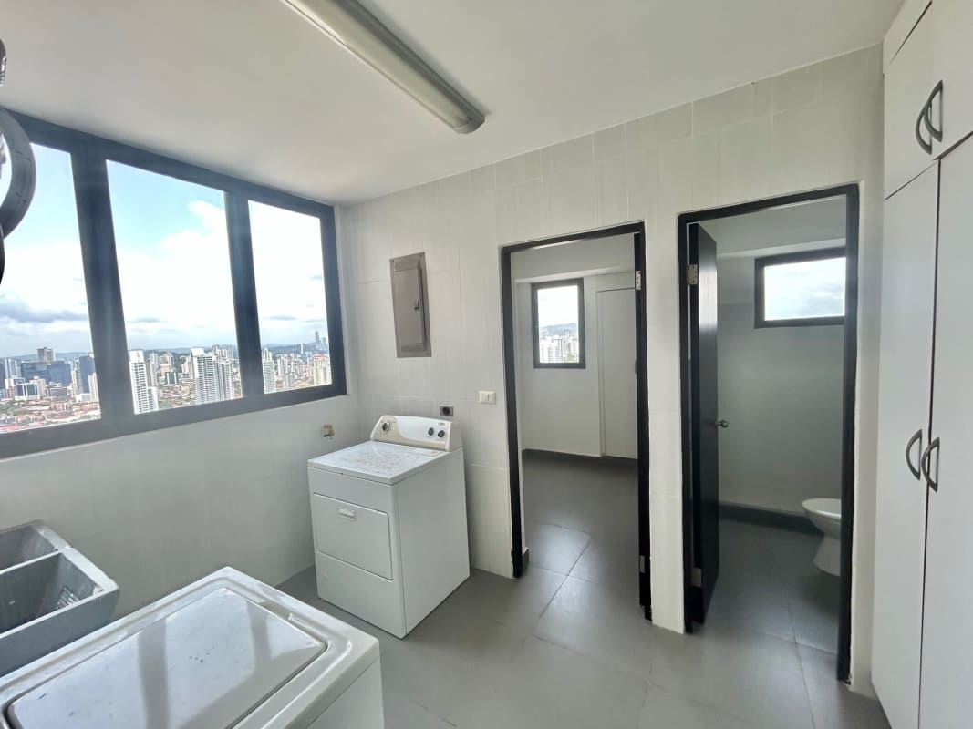 Master bedroom with large windows and ocean skyline views in PH San Francisco Bay Panama