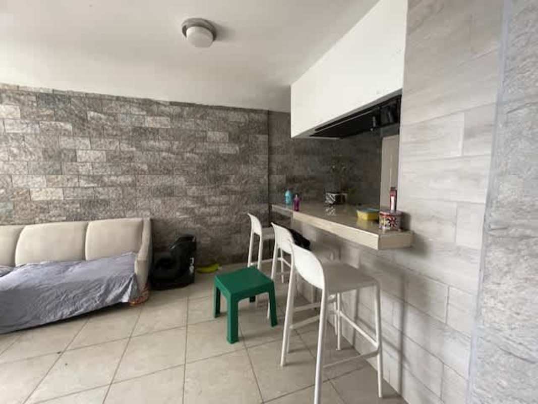Bedroom with rustic wood accent wall, bed and AC at PH Mystic Tower Panama City