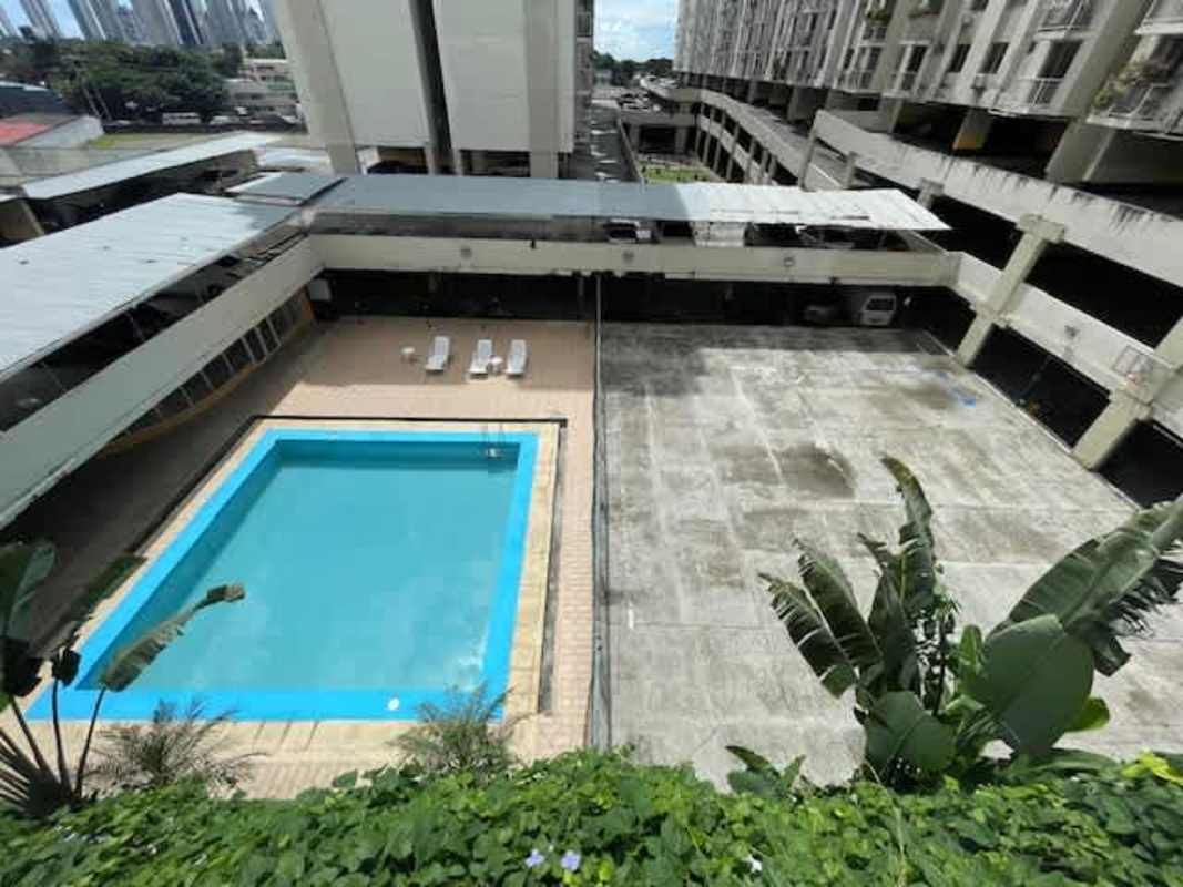 Bedroom with wood-style accent wall, split air conditioning, and closet at PH Mystic Tower Panama City