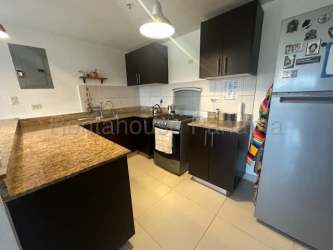 Modern granite countertop kitchen with appliances in Woodlands Midrise Panama Pacifico