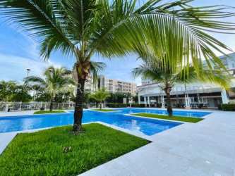 Balcony overlooking gardens and pool area in Woodlands Midrise Panama Pacifico apartment
