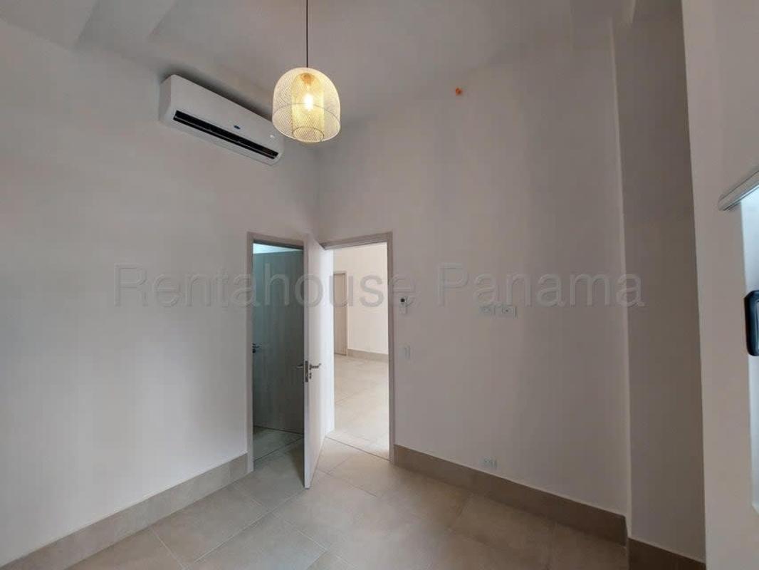 Lounge area with floor to ceiling windows and coworking space Ocean House Santa Maria
