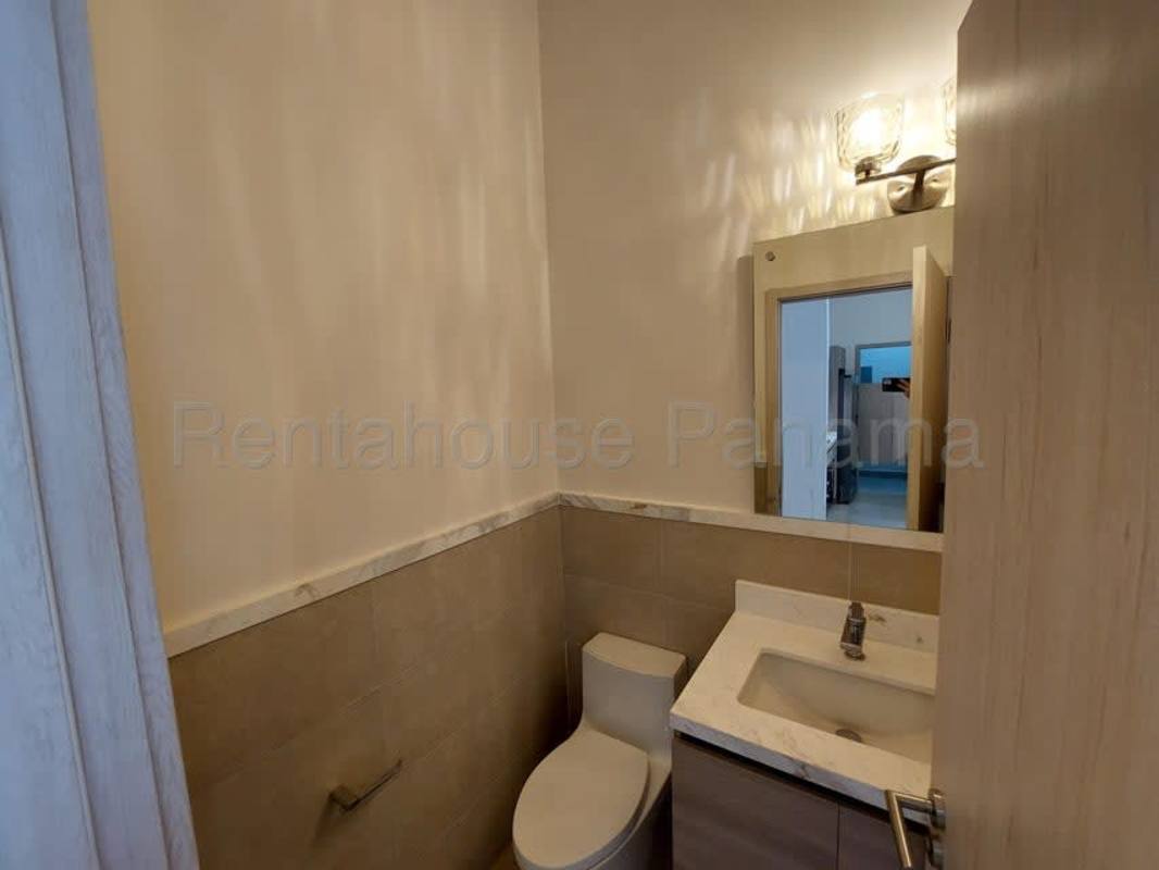 Contemporary kitchen with built-in appliances and stone countertops in luxury Ocean House apartment