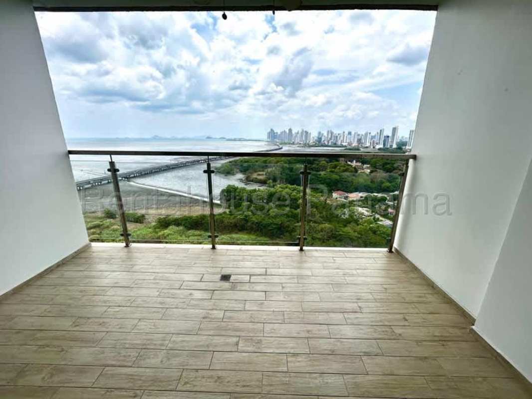 Spacious terrace balcony with glass railing overlooking Pacific Ocean and city in PH Bali Costa del Este