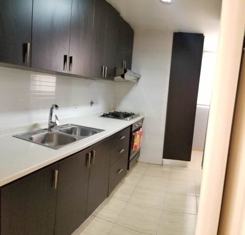 Living room with large window, tile floors, AC, balcony access in PH Via Argentina Panama City apartment