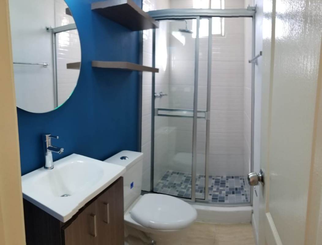 Bedroom featuring built-in wardrobe, AC unit, large window in PH Via Argentina rental Panama City